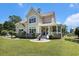 Traditional home with a rounded porch, lush lawn, and beautiful landscaping at 5460 Huntington Marsh Rd., Murrells Inlet, SC 29576