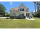 Charming home featuring a rounded porch, lush lawn, and well-maintained landscaping at 5460 Huntington Marsh Rd., Murrells Inlet, SC 29576