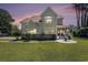 Charming home featuring a rounded porch, lush lawn, and well-maintained landscaping at 5460 Huntington Marsh Rd., Murrells Inlet, SC 29576