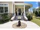 Inviting front porch featuring decorative flower pots and elegant white columns at 5460 Huntington Marsh Rd., Murrells Inlet, SC 29576