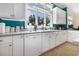 Bright kitchen featuring white cabinetry, stainless steel appliances, and a large window at 5460 Huntington Marsh Rd., Murrells Inlet, SC 29576
