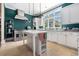 Gourmet kitchen boasts custom cabinets, a large center island, and high-end stainless steel appliances at 5460 Huntington Marsh Rd., Murrells Inlet, SC 29576
