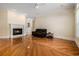 Bright living room featuring a marble fireplace, rich hardwood floors, and comfortable seating at 5460 Huntington Marsh Rd., Murrells Inlet, SC 29576