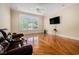 Bright living room features hardwood floors, large windows and a media center for entertainment at 5460 Huntington Marsh Rd., Murrells Inlet, SC 29576