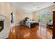 Spacious main bedroom featuring hardwood floors, a fireplace, and plenty of natural light at 5460 Huntington Marsh Rd., Murrells Inlet, SC 29576