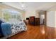 Large main bedroom with hardwood floors, window and furniture at 5460 Huntington Marsh Rd., Murrells Inlet, SC 29576