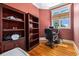 Cozy home office featuring built-in bookshelves, hardwood floors, and a window at 5460 Huntington Marsh Rd., Murrells Inlet, SC 29576