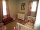 Bedroom with a changing table, crib, and multiple windows at 5578 Dongola Hwy., Conway, SC 29527