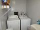 Functional laundry room with washer, dryer, shelving, and cleaning supplies at 5578 Dongola Hwy., Conway, SC 29527