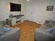 Bright living room with hardwood floors, comfortable sofas, and a wall-mounted TV at 5578 Dongola Hwy., Conway, SC 29527