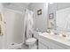 Clean, white bathroom featuring a shower, toilet, vanity, and stylish blue accents at 5852 Longwood Dr. # 302, Murrells Inlet, SC 29576