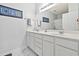 Bright bathroom featuring double vanity with white cabinets and a large framed mirror at 5852 Longwood Dr. # 302, Murrells Inlet, SC 29576