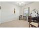 Well-lit bedroom featuring a vanity, mirror, large window and neutral walls and flooring at 5852 Longwood Dr. # 302, Murrells Inlet, SC 29576