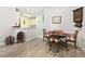 Cozy dining room with hardwood floors and traditional furnishings adjacent to the kitchen, perfect for Gathering meals at 5852 Longwood Dr. # 302, Murrells Inlet, SC 29576