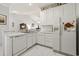 Bright kitchen featuring white cabinetry, marble countertops, and modern appliances including a dishwasher and refrigerator at 5852 Longwood Dr. # 302, Murrells Inlet, SC 29576