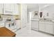 Bright, white kitchen featuring tile flooring, an oven, microwave, dishwasher, and wood accents at 5852 Longwood Dr. # 302, Murrells Inlet, SC 29576