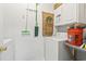 A well-lit laundry area with washer, shelves, cleaning supplies, and storage cabinets at 5852 Longwood Dr. # 302, Murrells Inlet, SC 29576