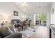 Inviting living room with a sliding glass door leading to a balcony, offering natural light and scenic views at 5852 Longwood Dr. # 302, Murrells Inlet, SC 29576