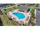 Aerial shot of a heart shaped community pool surrounded by lounge chairs and green landscaping at 5852 Longwood Dr. # 302, Murrells Inlet, SC 29576
