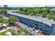 Aerial view showcases the building's structure, parking lot, and surrounding lush trees, with a glimpse of the ocean at 5905 South Kings Hwy. # 5202, Myrtle Beach, SC 29575