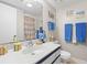 Bright bathroom with a vanity, blue towels and a beach-themed shower curtain at 5905 South Kings Hwy. # 5202, Myrtle Beach, SC 29575