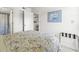 Relaxing bedroom with a floral patterned bedspread, leading to the bathroom and kitchen area at 5905 South Kings Hwy. # 5202, Myrtle Beach, SC 29575