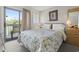 Comfortable bedroom with a floral patterned bedspread and access to a private balcony with outdoor seating at 5905 South Kings Hwy. # 5202, Myrtle Beach, SC 29575