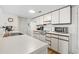 A well lit kitchen featuring white cabinets and appliances at 5905 South Kings Hwy. # 5202, Myrtle Beach, SC 29575