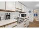 Kitchen with white appliances, countertop, and cabinets. Also an adjacent bathroom at 5905 South Kings Hwy. # 5202, Myrtle Beach, SC 29575