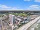 Aerial view of beachfront resort featuring a tall condo building, pool, and beach access at 5905 South Kings Hwy. # A518, Myrtle Beach, SC 29575