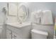 Well-lit bathroom with white vanity, oval mirror, and hanging white towels at 5905 South Kings Hwy. # A518, Myrtle Beach, SC 29575