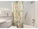 Bathroom featuring a shower with a patterned curtain, a toilet, and towel racks at 5905 South Kings Hwy. # A518, Myrtle Beach, SC 29575