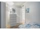 Bright bedroom with a white dresser, round mirror, and doorway leading to other parts of the home at 5905 South Kings Hwy. # A518, Myrtle Beach, SC 29575