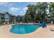 Large outdoor community pool surrounded by lounge chairs and lush landscaping at 5905 South Kings Hwy. # A518, Myrtle Beach, SC 29575