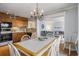 Eat-in kitchen with a bright dining table, wooden cabinets, and views into the living room at 5905 South Kings Hwy. # A518, Myrtle Beach, SC 29575