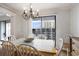 Bright dining room with white chairs, tile-topped table, chandelier, and sliding glass doors at 5905 South Kings Hwy. # A518, Myrtle Beach, SC 29575