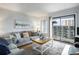 Cozy living room with comfortable seating, sliding glass doors to a balcony, and nautical décor at 5905 South Kings Hwy. # A518, Myrtle Beach, SC 29575