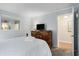 Cozy main bedroom with wooden furniture, a TV, and access to the ensuite bathroom at 5905 South Kings Hwy. # A518, Myrtle Beach, SC 29575