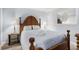 Main bedroom featuring wooden bed frame, lamps, side tables, and white bedding at 5905 South Kings Hwy. # A518, Myrtle Beach, SC 29575