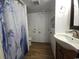 Functional bathroom featuring a modern vanity, a shower with a decorative curtain, and practical design elements at 6001 S Kings Hwy., Myrtle Beach, SC 29575