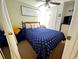 Cozy bedroom featuring a comfortable bed with a blue patterned cover and a ceiling fan for added comfort at 6001 S Kings Hwy., Myrtle Beach, SC 29575