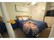 Cozy bedroom featuring a comfortable bed with a blue patterned cover, complemented by charming decorative touches at 6001 S Kings Hwy., Myrtle Beach, SC 29575