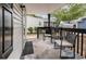 This covered porch is furnished with outdoor seating, an area rug, and string lights at 6001 S Kings Hwy., Myrtle Beach, SC 29575
