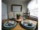 Cozy dining setting showcasing a decorated table with plates and center piece, creating a warm and inviting atmosphere at 6001 S Kings Hwy., Myrtle Beach, SC 29575