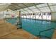 Indoor pool with a retractable roof, several swimmers, and a pool wheelchair lift at 6001 S Kings Hwy., Myrtle Beach, SC 29575
