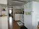 Bright kitchen featuring white appliances, cabinets, and a view into another room, creating a cozy atmosphere at 6001 S Kings Hwy., Myrtle Beach, SC 29575