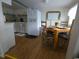 Bright kitchen and dining area featuring modern appliances and warm wood laminate flooring at 6001 S Kings Hwy., Myrtle Beach, SC 29575