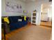 Open living area with a sofa, artwork, a wooden cabinet, and access to the kitchen at 6001 S Kings Hwy., Myrtle Beach, SC 29575