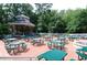 Lots of outdoor seating on a wooden deck under a gazebo surrounded by a lush green tree landscape at 6001 S Kings Hwy., Myrtle Beach, SC 29575
