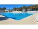 Large, inviting outdoor pool surrounded by lounge chairs and lush greenery, offering a relaxing atmosphere at 6001 S Kings Hwy., Myrtle Beach, SC 29575